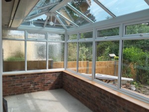 Inside-of-conservatory-installation-with-glass-roof-and-sides