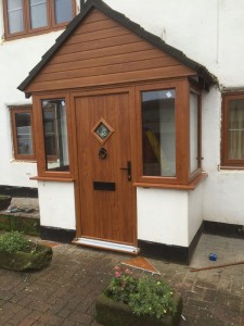 UPVC porch Windows and composite door UPVC golden oak-cladding-above-door